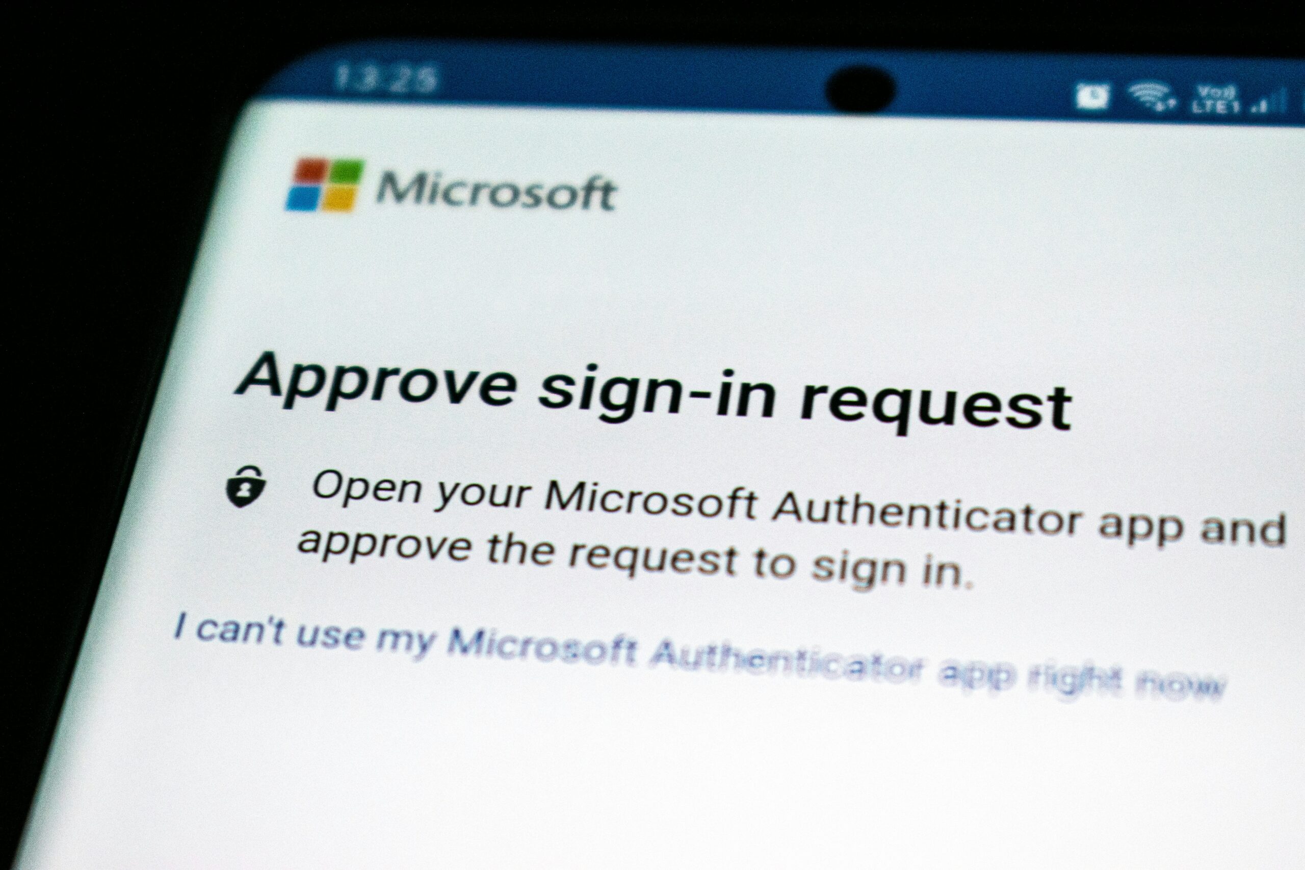 MFA authentication prompt on smartphone in identity-based cyberattack scenario Smartphone displaying authentication and login approval prompts used in multi-factor authentication (MFA) during identity-based cyberattacks.